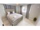 Comfortable bedroom with a queen bed, neutral decor, and natural lighting at 608 Saint Judes Dr, Longboat Key, FL 34228