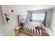 Bedroom features tiled floors, a neutral palette, and a window in a well-designed space at 608 Saint Judes Dr, Longboat Key, FL 34228