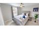 Bright bedroom features a ceiling fan, neutral palette, and a window with views at 608 Saint Judes Dr, Longboat Key, FL 34228
