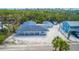 Charming single-story home with a large yard, lush landscaping, and a detached garage at 608 Saint Judes Dr, Longboat Key, FL 34228