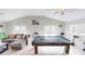 Game room with billiard table, comfortable seating, and bright natural light at 608 Saint Judes Dr, Longboat Key, FL 34228