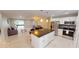 Open kitchen featuring an island with breakfast bar, stainless steel appliances, and ample cabinet space at 608 Saint Judes Dr, Longboat Key, FL 34228