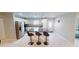 Modern kitchen featuring an island with bar seating, stainless steel appliances, and stylish countertops at 608 Saint Judes Dr, Longboat Key, FL 34228