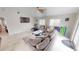 Spacious living area with a sectional sofa, large windows, and a TV at 608 Saint Judes Dr, Longboat Key, FL 34228