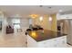 Spacious living room flows into an open-concept kitchen featuring a large island and modern appliances at 608 Saint Judes Dr, Longboat Key, FL 34228