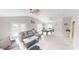 Spacious living area leading to game room, features neutral colors and tile flooring at 608 Saint Judes Dr, Longboat Key, FL 34228