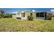 Spacious backyard featuring lush green grass and a well-maintained exterior of the home at 6293 Sparrow Ln, Englewood, FL 34224