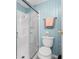 Clean bathroom featuring a glass-enclosed shower stall, toilet, and a towel rack at 6293 Sparrow Ln, Englewood, FL 34224