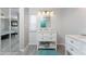 Charming bathroom with vanity and plenty of storage; the door is mirrored at 6293 Sparrow Ln, Englewood, FL 34224