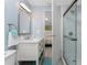 A lovely, bright bathroom with a shower, vanity, toilet, towels, and decor at 6293 Sparrow Ln, Englewood, FL 34224