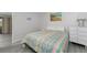 Bright bedroom with a cozy bed, art, a window view, and a chest of drawers with a lamp at 6293 Sparrow Ln, Englewood, FL 34224