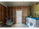 Bright laundry room with a washer and dryer, featuring framed walls and various accessories at 6293 Sparrow Ln, Englewood, FL 34224