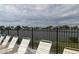 Several lounge chairs by the pool offer serene lake views in a tranquil setting at 6293 Sparrow Ln, Englewood, FL 34224