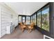 Sun room with a glass table, chairs, and large windows for natural lighting at 6293 Sparrow Ln, Englewood, FL 34224