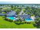 Aerial view showcasing the community pool and clubhouse, surrounded by lush greenery and manicured lawns at 7337 Desant Ln, Port Charlotte, FL 33981