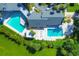 An aerial view of a community pool and a well maintained green space area on a sunny day at 7337 Desant Ln, Port Charlotte, FL 33981
