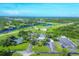 Expansive aerial view showcasing the community's amenities, including a river, tennis courts, and parking at 7337 Desant Ln, Port Charlotte, FL 33981