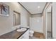 Bathroom features a vanity with sink, commode, and a step-in shower at 7337 Desant Ln, Port Charlotte, FL 33981