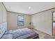 Bedroom features paneled walls, hardwood floors, and a large window at 7337 Desant Ln, Port Charlotte, FL 33981