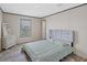 Bright bedroom features wood-look floors, paneled walls, and a window with natural light at 7337 Desant Ln, Port Charlotte, FL 33981