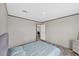 Bedroom with wood-look floors and paneled walls with open doorway to other rooms at 7337 Desant Ln, Port Charlotte, FL 33981