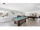 Bright and inviting game room featuring pool tables, natural light, and stylish decor at 7337 Desant Ln, Port Charlotte, FL 33981