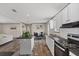 Open concept kitchen with stainless appliances, kitchen island, and adjacent dining area at 7337 Desant Ln, Port Charlotte, FL 33981