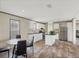 Modern kitchen design showcasing an island, dining area, stainless refrigerator, and lots of light at 7337 Desant Ln, Port Charlotte, FL 33981