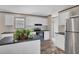 Well-lit kitchen with white cabinets, an island, and modern appliances at 7337 Desant Ln, Port Charlotte, FL 33981
