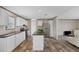 Bright, open kitchen with stainless steel appliances, white cabinetry, and wood-look flooring at 7337 Desant Ln, Port Charlotte, FL 33981