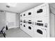 Clean laundry room equipped with multiple washers and dryers for convenient use at 7337 Desant Ln, Port Charlotte, FL 33981