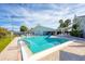 Outdoor pool with inviting clear water, complemented by a covered seating area for relaxing and socializing at 7337 Desant Ln, Port Charlotte, FL 33981