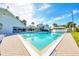Beautiful outdoor pool with clear water, surrounded by a covered patio and lush landscaping at 7337 Desant Ln, Port Charlotte, FL 33981