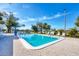 Sparkling outdoor pool area surrounded by ample seating and beautiful landscaping for relaxation at 7337 Desant Ln, Port Charlotte, FL 33981