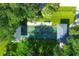 Aerial view of two community shuffleboard courts shaded by trees, providing a cool area for entertainment at 7337 Desant Ln, Port Charlotte, FL 33981