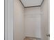 Empty walk-in closet with hanging rack and a window at 7337 Desant Ln, Port Charlotte, FL 33981