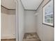 Walk-in shower with modern fixtures and an adjacent closet space at 7337 Desant Ln, Port Charlotte, FL 33981