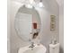 Bright bathroom featuring a large mirror, white sink, and neutral decor at 8228 Villa Grande Ct, Sarasota, FL 34243