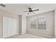 Bright bedroom features a ceiling fan, double windows, a closet, and neutral-toned walls at 8228 Villa Grande Ct, Sarasota, FL 34243