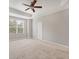 Spacious bedroom with a ceiling fan, neutral walls, and ample natural light from the window at 8228 Villa Grande Ct, Sarasota, FL 34243