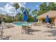 Community pool area with sun loungers and shaded seating at 8228 Villa Grande Ct, Sarasota, FL 34243