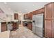 Modern kitchen with stainless steel appliances, tile backsplash, granite countertops, and hardwood cabinets at 8228 Villa Grande Ct, Sarasota, FL 34243