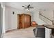 Comfortable living room featuring hardwood floors, a media center, and stairs leading to the upper level at 8228 Villa Grande Ct, Sarasota, FL 34243