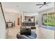 Comfortable living room featuring hardwood floors and an open layout with a view of the kitchen and backyard patio at 8228 Villa Grande Ct, Sarasota, FL 34243