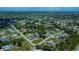 Aerial view of a town with houses, buildings, streets and lots of trees at 9325 Crugar Ter, Englewood, FL 34224