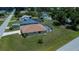 Aerial view of a single-Gathering home with green lawn, driveway and a screened-in pool at 9325 Crugar Ter, Englewood, FL 34224