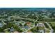 An aerial view of a residential neighborhood nestled among lush greenery and waterways at 9325 Crugar Ter, Englewood, FL 34224