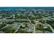 Wide aerial shot of a town with houses, buildings, streets, and bodies of water at 9325 Crugar Ter, Englewood, FL 34224