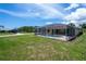 Spacious backyard featuring a screened-in pool, perfect for outdoor relaxation and entertainment at 9325 Crugar Ter, Englewood, FL 34224