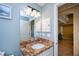 Well-lit bathroom showcasing a granite vanity top, updated lighting and neutral paint at 9325 Crugar Ter, Englewood, FL 34224